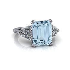 Emerald Cut Aquamarine ring, perfect for engagement or anniversary.GEMSTONES: Emerald cut aquamarine 10x8 mm, 2.95 ct. Round lab grown genuine diamonds, F color VS clarity, .75 ct.*Band width 1.9mm.*3.70 carat total weight.*The ring is custom made just for you in your ring size and metal preference. It is offered in solid gold, and solid platinum. Other metals are available upon request.*Please feel free to contact us with any questions or custom requests.*All purchases are shipped via USPS or f Emerald Cut Topaz Ring With Diamond Accents For Anniversary, Fine Aquamarine Diamond Ring With Accent Stones, Aquamarine Diamond Ring With Accent Stones, Classic Aquamarine Diamond Ring With Accent Stones, Classic Diamond Ring With Aquamarine Accent Stones, Emerald Cut Aquamarine Diamond Promise Ring, Fine Jewelry Emerald Cut Topaz Ring Gia Certified, Formal Emerald Cut Aquamarine Diamond Ring, Formal Emerald-cut Aquamarine Diamond Ring