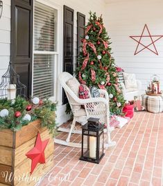 a christmas tree is on the front porch