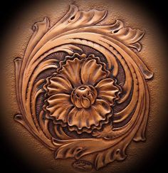 an intricately carved design on the side of a brown leather wallpapered surface