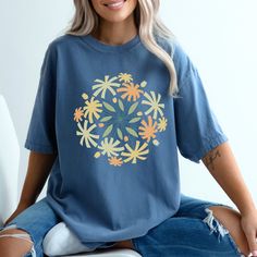 Step into spring with our enchanting Comfort Colors t-shirt adorned with beautiful retro floral graphics! Embrace the season in style as you wrap yourself in the cozy comfort of our high-quality, pre-shrunk cotton tee. Indulge your senses with the timeless charm of vintage-inspired florals that burst with color, evoking the essence of a blooming spring garden. Crafted on a canvas of soft, breathable fabric, this shirt promises not only a delightful visual experience but also a soothing feel agai Retro Short Sleeve T-shirt With Floral Print, Spring Floral Print Graphic Tee, Retro Floral Print T-shirt With Short Sleeves, Spring Graphic Tee With Print, Retro Cotton T-shirt With Floral Print, Blue Plant Print Crew Neck Top, Retro Floral Print Crew Neck Tops, Blue Plants Print Short Sleeve T-shirt, Floral Print Crew Neck Graphic Tee