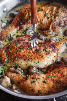 a pan filled with chicken and mushrooms covered in gravy