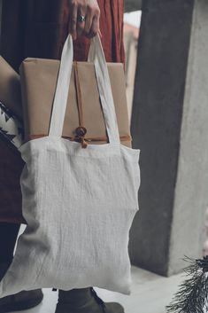 "DETAILS *Ivory linen bag is suitable as a gift bag *Bag fits perfectly in your handbag and assist you anytime *Linen bag with few linen towels can be a great gift too *Made from soft wash medium weight (185 g) 100 % European linen fabric *Color - ivory. Please choose another color on the right *Handmade in Lithuania by creative tailors CARE LABEL * machine wash gentle (40 C/104 F) * dry gentle on low heat * wrinkles give the character so there is no need to iron, but if you still prefer it - ir Natural Everyday Bag For Gifts, Linen Tote Bag For Shopping, Beige Linen Shopping Bag, Eco-friendly Cream Canvas Bag As Gift, Rectangular Linen Shopping Bag, Cream Cotton Bags For Gifts, Eco-friendly Cream Canvas Bag For Gifts, Eco-friendly Cream Canvas Bag Gift, Eco-friendly White Shoulder Bag With Dust Bag