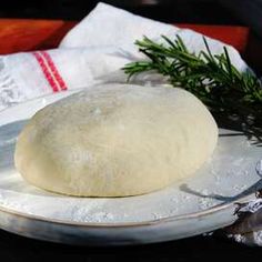 a white plate topped with a doughnut next to a knife and napkin on top of a table