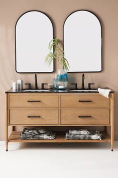 two mirrors are above the double sink vanity