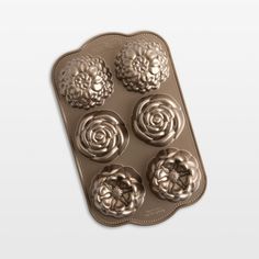 four flower shaped chocolate molds in a tray