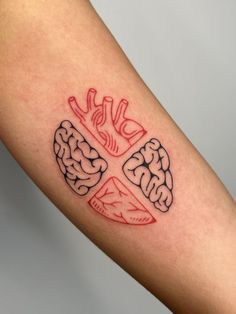 a tattoo on the arm of a person with a cross and brain in the middle