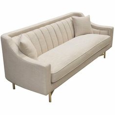 a white couch with two pillows on it's back and one arm folded down