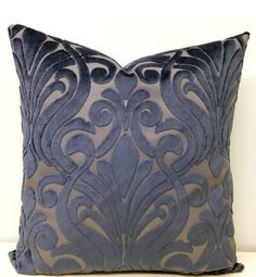 a black and grey decorative pillow on a white table