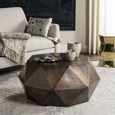 a living room with a couch, coffee table and two vases on the floor