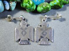 Item Details New Navajo silver art. Photos are part of the condition details. Listing is for earrings only. Coin & background decor not included. TY~. Unsigned by Sun West Silver. Earrings hang 1&1/4" Nad are 1/2" across. Each ThunderBird measures 3/4" x 1/2". Sterling French style ear wires. Weighs 4 grams combined. Silver Southwestern Style Earrings For Gift, Silver Southwestern Style Earrings For Gifting, Silver Southwestern Earrings For Gift, Southwestern Silver Earrings For Gifts, Collectible Silver Jewelry With Matching Earrings, Background Decor, Art Photos, Silver Art, French Style