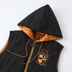 a black vest with an orange hoodie on it and a brown zipper down the front