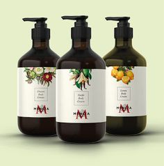 three bottles of hand soap with labels on them, each containing different types of flowers