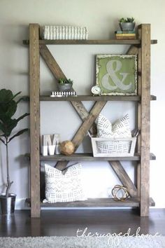 a shelf made out of wooden boards with decorative items on top and some plants in the corner