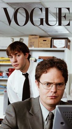 two men in suits and ties looking at a computer screen with the word voge on it