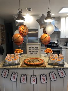 a basketball themed birthday party with oranges and cupcakes on the counter top