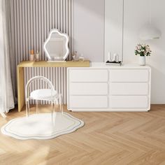 a white dresser sitting next to a mirror on top of a wooden floor in a room