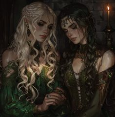 two beautiful women dressed in green standing next to each other with long hair and jewelry