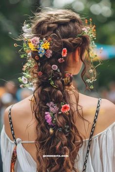 a woman with long hair and flowers in her hair is wearing a flower crown on her head