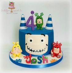 a birthday cake with the number four on it's face and three cartoon figures