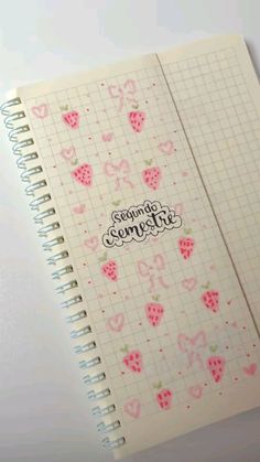 an open notebook with strawberries on it