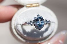 a close up of a ring with a blue stone in it's center and inside