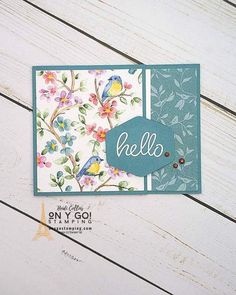 a close up of a card on a wooden surface with the word hello written in it