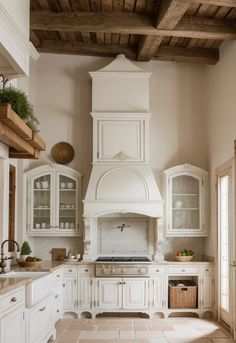 a large kitchen with white cabinets and an oven in it's center island area