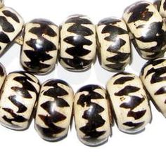 several black and white beads are lined up together