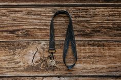 a lanyard with two keys attached to it on a wooden background, top view