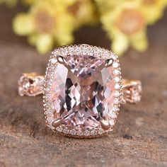 an engagement ring with a pink diamond surrounded by diamonds