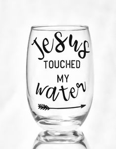 a wine glass that says jesus touched my water