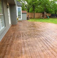 a wooden deck in front of a house