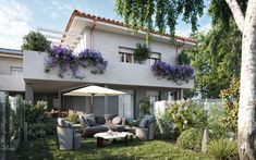 a house with flowers on the balconies and patio furniture