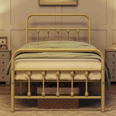 a gold metal bed frame with green sheets and pillows in a neutral bedroom setting on carpeted flooring