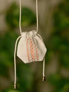 a small white bag hanging from a string