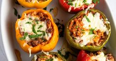 several stuffed peppers with meat and cheese on them