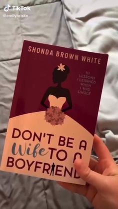 a person holding up a book with the title don't be a wife to a boyfriend