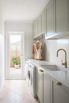 a washer and dryer in a white laundry room