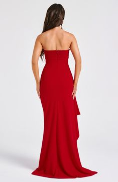 a woman in a red dress with her back to the camera