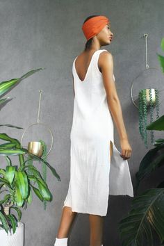 Introducing the latest addition to Ngo Bolingo's collection: the Cotton Tank Dress. Handcrafted with care, this dress is a stunning embodiment of comfort and style, created from 100% soft double crepe gauze cotton fabric. FINALLY SALE, NO RETURN ON SALE ITEMS Features: -Effortless Elegance: The white textured cotton tank dress effortlessly combines comfort and sophistication. -18-Inch Side Slits: Striking high side slits, measuring 18 inches, add a touch of allure and movement to your ensemble. Beach Dress With Split Hem For Summer, Summer Beach Dress With Split Hem, Summer Beach Dresses With Split Hem, Beach Maxi Dress With Side Slits And Split Hem, Beach Maxi Dress With Side Slits, Long Midi Dress With Side Slits For Beach, Split Hem Dress For Vacation, Beach Midi Dress With Split Design, Summer Dresses With Side Slits And Split Hem