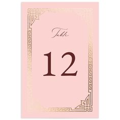 a pink and gold table number card with the word, thank 12 in black on it