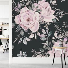 a black and white floral wallpaper with pink flowers on the side, next to a table