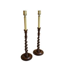 two wooden candlesticks sitting next to each other