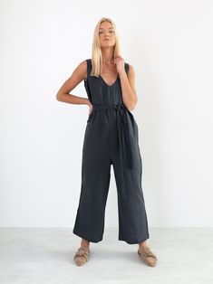 "MADELINE is a sleeveless loose fit linen jumpsuit. DETAILS - V-neckline on front and back - Wide cropped leg - Self tie belt - 100% lightweight European linen fabric - Cut and sewn to order just for you in our studio COLOR - Dark grey, you can also choose other colors above - Fabric samples are available here https://www.etsy.com/listing/586569696/linen-fabric-samples SIZING & FIT - Relaxed, loose fit - Length is approximately 52 inches / 132 cm - Bust (pit to pit) is approximately 18 inche Elegant Linen Jumpsuits And Rompers For Beach, Summer Linen Belted Jumpsuits And Rompers, Spring Linen Belted Jumpsuits And Rompers, Casual Linen Belted Jumpsuits And Rompers, Chic Linen Jumpsuits And Rompers With Tie Waist, Elegant Sleeveless Linen Jumpsuit, Spring Linen V-neck Jumpsuit, Linen V-neck Jumpsuits And Rompers For Spring, Linen Belted Jumpsuits And Rompers