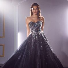 The Magnificent Ball Gown Silhouette Dress Has A Structural Top Decorated With Sparkling Rhinestones That Give The Image Uniqueness. This Product Has A Multi-Layered Floor-Length Skirt. An Inconspicuous Zipper On The Back Will Ensure A Secure Fixation Of The Dress. Length: Long Colour: Black Neckline: Off Shoulder Silhouette: Ball Gown Sleeve: Sleeveless Back: Semi-Open, Zipper Skirt: Floor Length Embellishments: Rhinestones Occasion: Romantic Date/Evening/Dinner, Wedding/Bridesmaid, Graduation, Glamorous Sleeveless Sequined Ball Gown, Glamorous Ball Gown With Fitted Bodice And Sleeveless Design, Glamorous Sleeveless Ball Gown With Fitted Bodice, Black Sparkle Prom Dress, Black Dress With Lined Bodice For Debutante Ball, Sleeveless Gown With Corset Back For Gala, Sleeveless Black Gown With Boned Bodice, Glamorous Sleeveless Ball Gown For Gala, Glamorous Sleeveless Dress For Debutante Ball