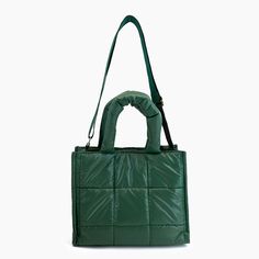 Puffer favorites are back in a plush all accessible square quilted puffer tote bag. This nylon purse is lightweight with secure closures and adjustable long strap for a crossbody option. A rich forest green colorway suitable for the holiday seasons. The perfect gift, diaper bag, work bag, or just everyday accessory to carry all your daily essentials. Composition: Nylon Dimensions: 11 1/2"W x 9 1/2"H x 5 1/2"D 6 1/2'' Top Handle 24" Adjustable/Detachable Strap Magnetic Closure 1 inner zipper pock Green Travel Bags For Winter, Green Large Capacity Bags For Winter, Green Winter Shoulder Bag, Green Winter Bags, Green Everyday Bag For Winter, Winter Quilted Nylon Shoulder Bag, Winter Green Shoulder Bag, Green Nylon Shoulder Bag With Double Handle, Green Rectangular Shoulder Bag For Winter