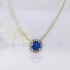 a necklace with a blue stone surrounded by diamonds