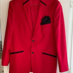 Red 2 Button Closure Red Blazer With Black Trim. Two Rear Side Vents. Lined With Flat Pockets. Four Black Buttons On Sleeves. No Size Or Material Tags. Measurements Laid Flat Are Approximately 18” Shoulders, 20” Armpit To Armpit, 25” Sleeves And 31” Length. Dry Clean Only. Msrp $74.99 Red Semi-formal Outerwear With Button Closure, Tailored Red Outerwear With Single Button, Tailored Red Single Button Outerwear, Red Tailored Single-button Outerwear, Red Long Sleeve Suits With Pockets, Red Semi-formal Outerwear With Pockets, Red Semi-formal Suits For Winter, Red Business Sport Coat With Pockets, Red Formal Blazer With Pockets