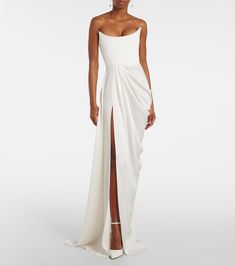 Bridal draped crêpe bustier gown in white - Alex Perry | Mytheresa Fitted Bodice Pre-draped Gown, Pre-draped Pleated Bodice Gown, Draped Gown With Fitted Bodice, Fitted Strapless Dress With Ruched Bodice, Pre-draped Strapless Gown With Ruched Bodice, Pre-draped Gown With Ruched Bodice And Strapless Design, Formal Pre-draped Strapless Dress, Fitted Bodice Draped Evening Dress, Ruched Fitted Bodice Pre-draped Gown