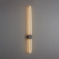 a wall mounted light that is on the side of a wall next to a white wall